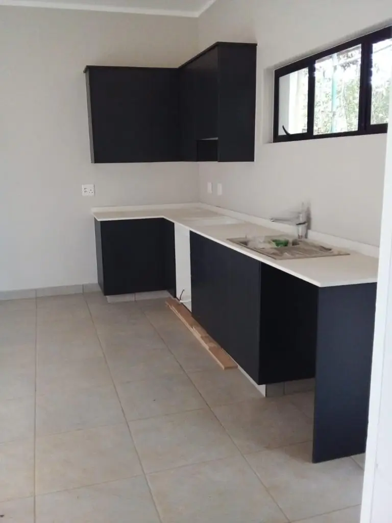 Kitchen cupboards correctly refitted and finished after poor carpentry work was fixed