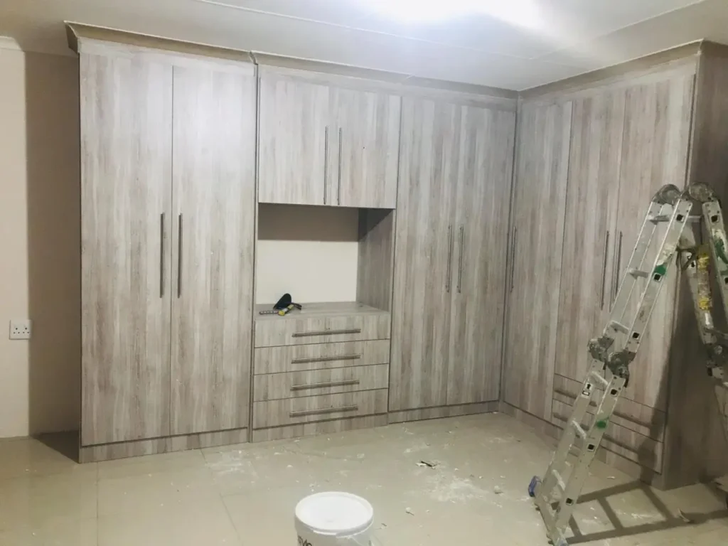 Built-in wardrobes and custom cupboards installed by a carpenter in Boksburg, showing clean finishes, fitted storage, and neat workmanship in a bedroom space.