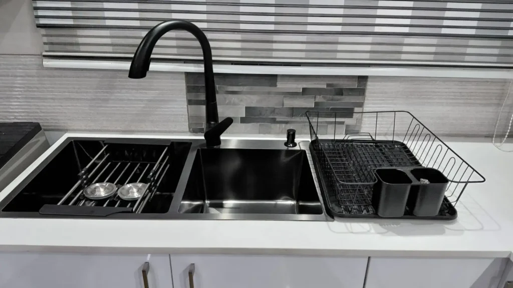 Close-up of a custom kitchen sink installation by a carpenter in Springs, showing a double black sink, modern tap, and neatly fitted countertop with clean finishes